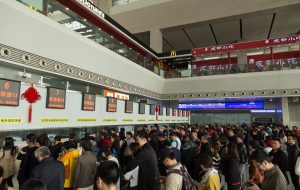 Passengers Queuing at a Railway Station in China